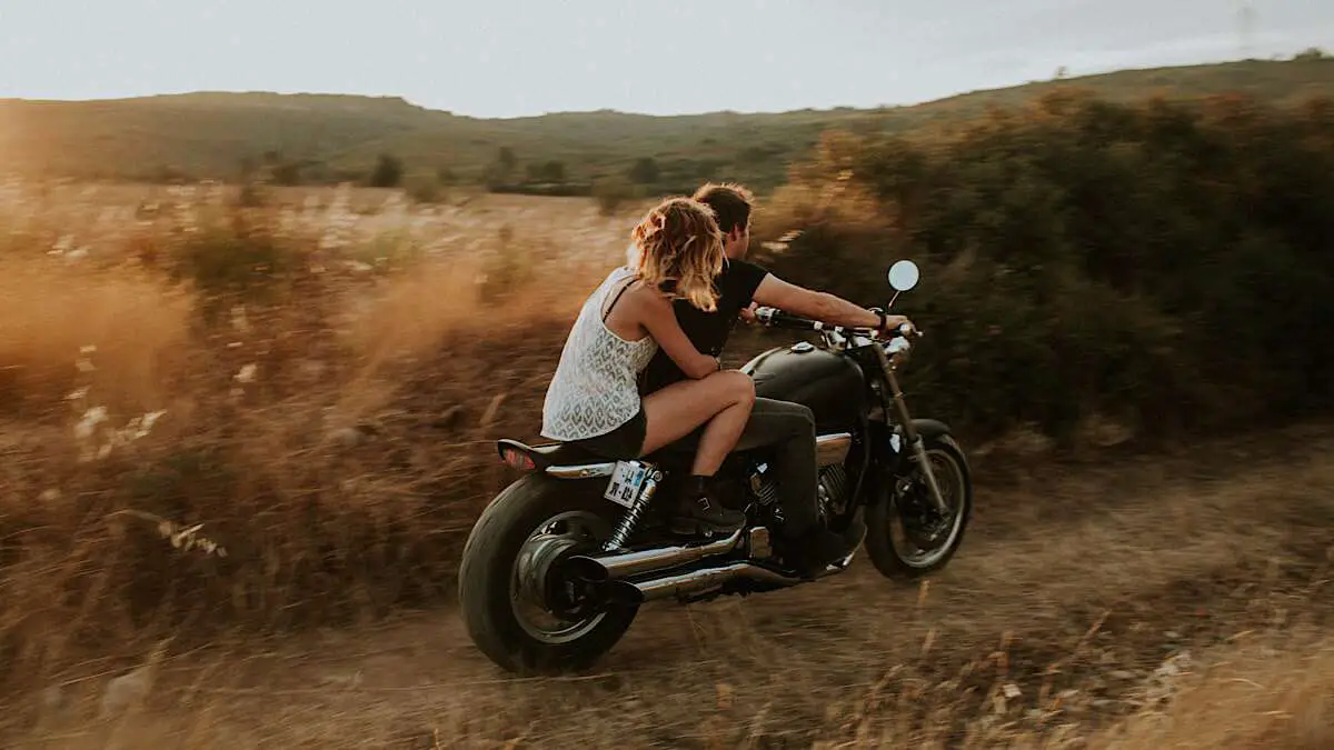 A couple riding a motorcycle