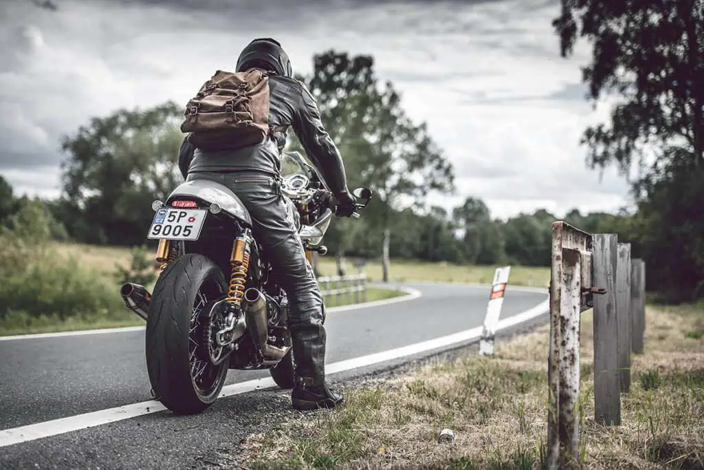 Man on motorcycle wearing leather pants