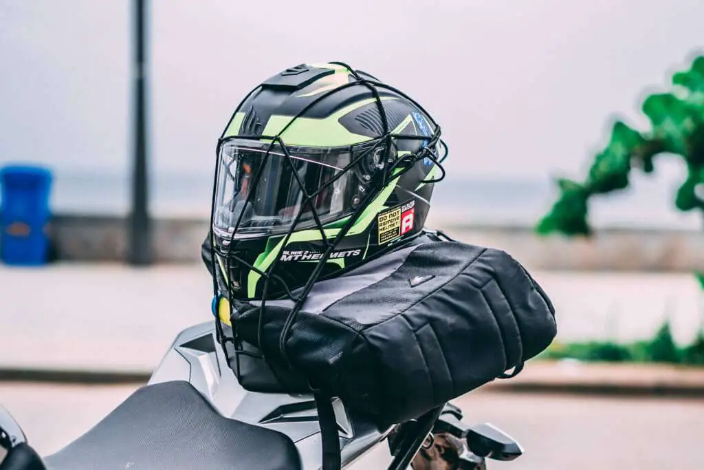 Motorcycle helmet strapped to the back of the motorcycle