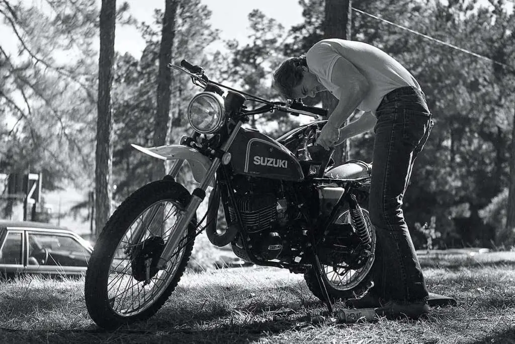 Man working on a Suzuki motorcycle engine