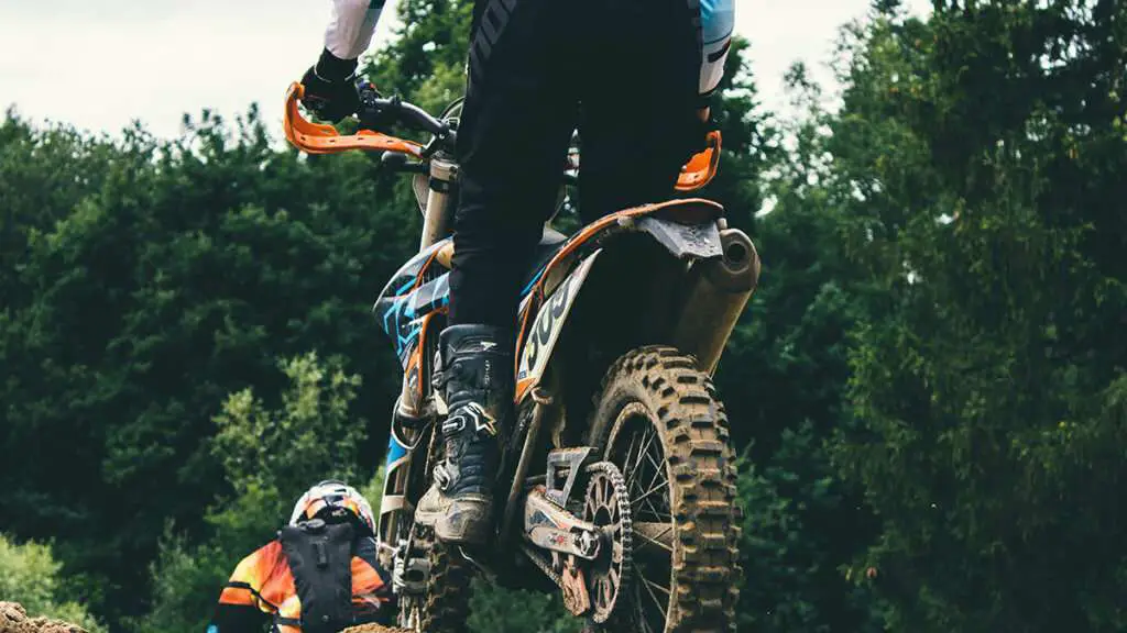 Man riding motocross standing up