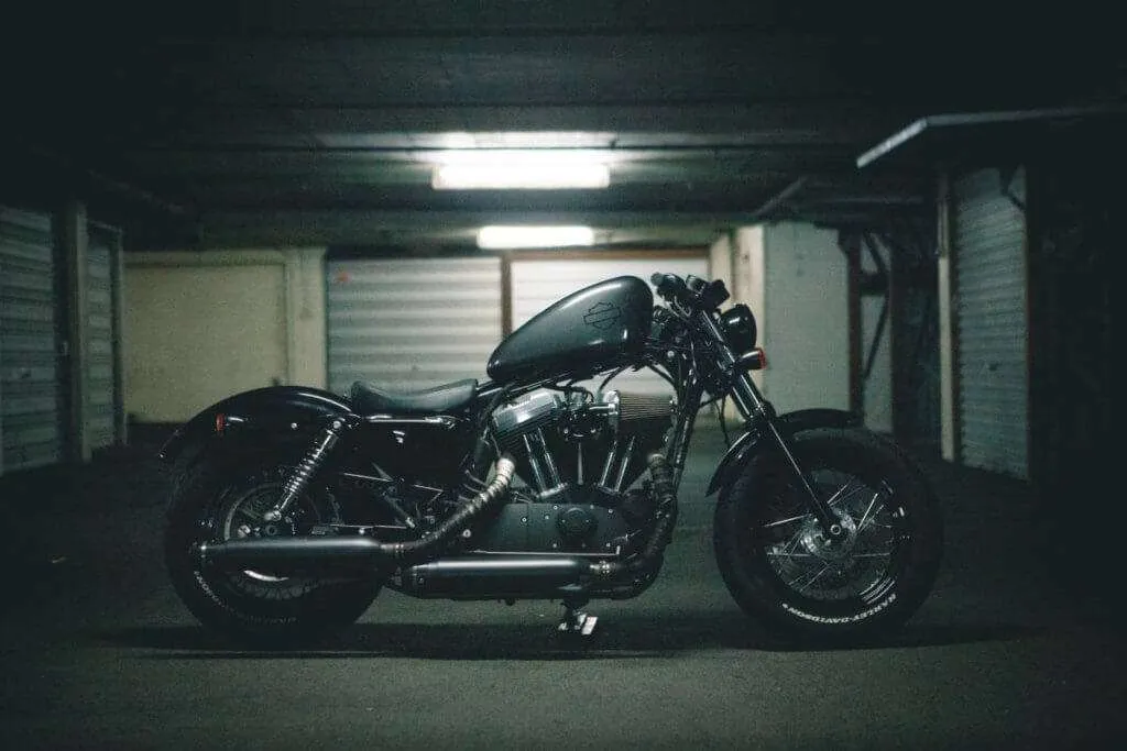 Black bobber motorcycle in a garage