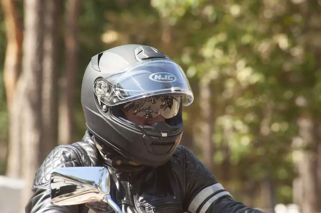 Rider wearing a black HJC motorcycle helmet
