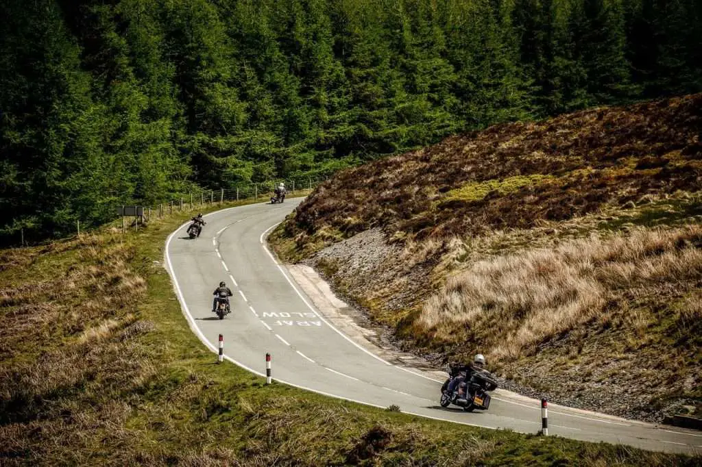 4 motorcycles touring on a curvy road