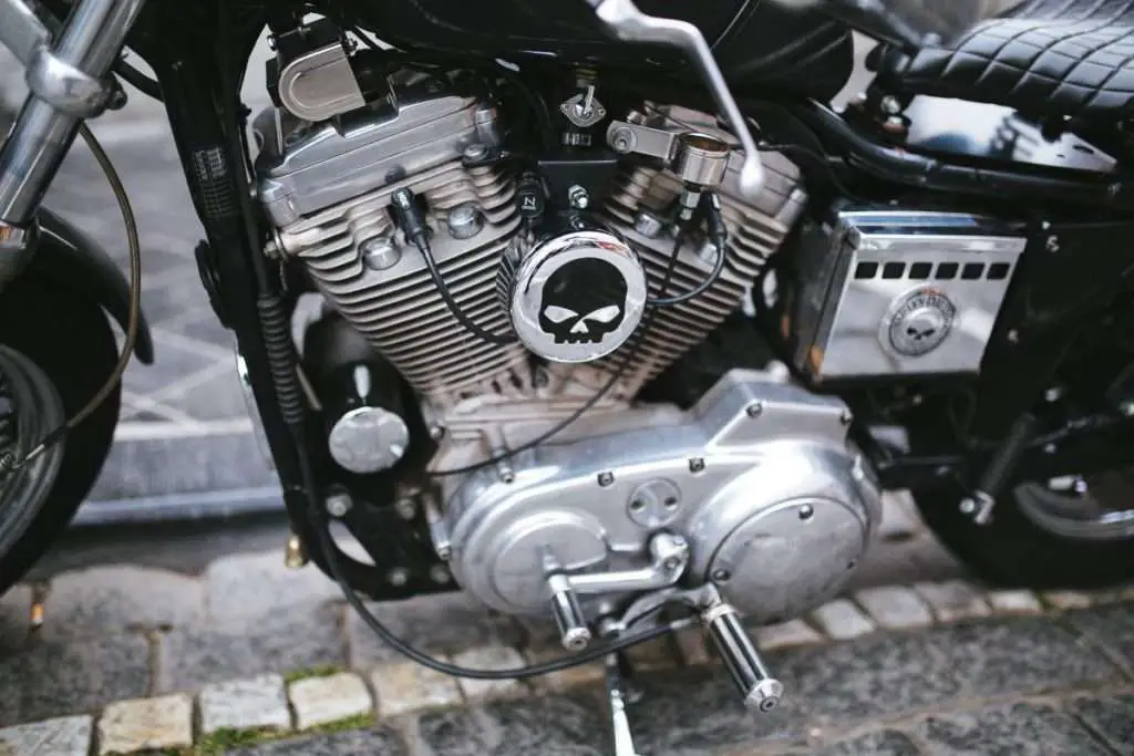 Close-up of a motorcycle engine with the punisher logo on it