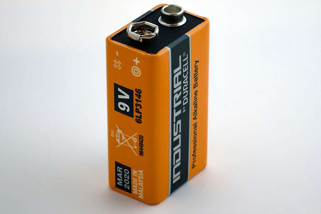 Close-up shot of a orange 9V battery