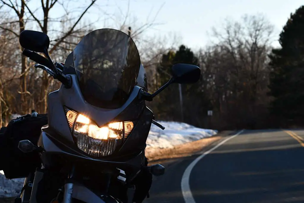 Motorcycle parked on the side of a winter road