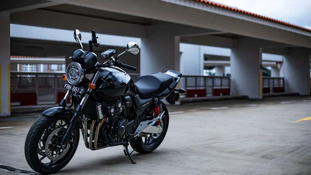 Black motorcycle parked in an empty garage
