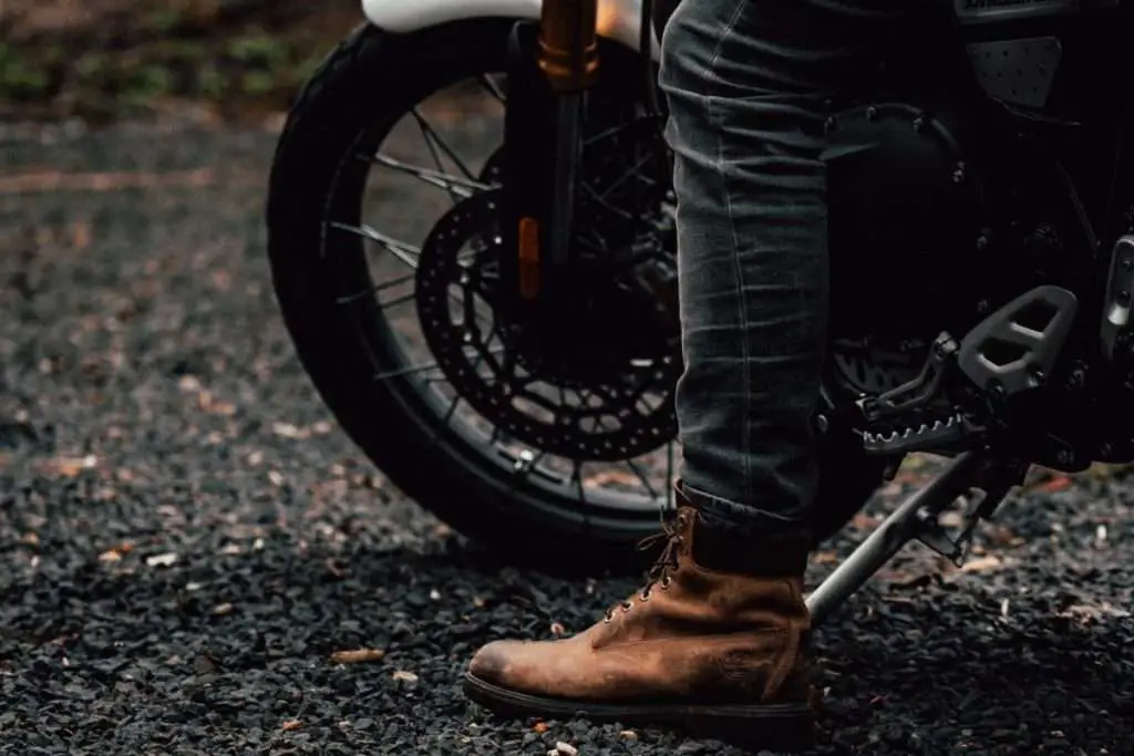 Motorcycle rider with boot on the ground