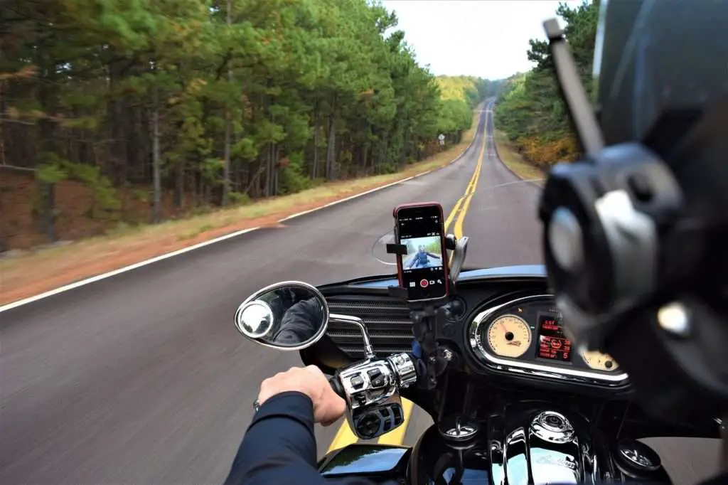 Motorcycle rider with phone on phone mount
