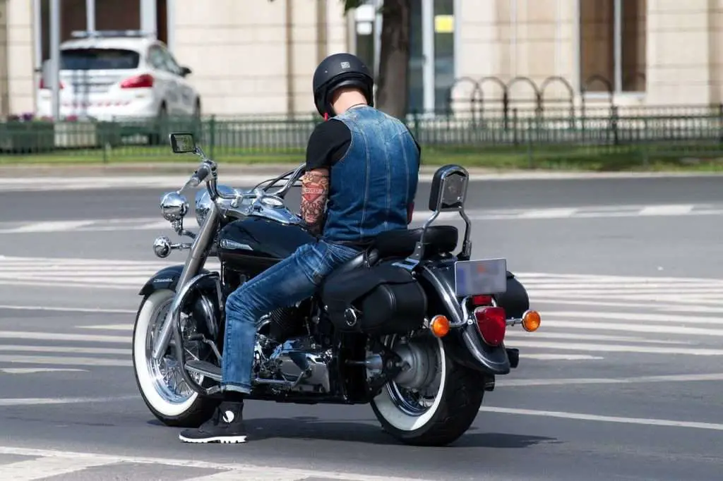 Man on a motorcycle sitting at a stop sign