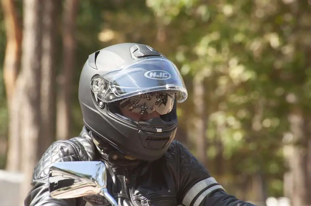 Person wearing a black motorcycle helmet