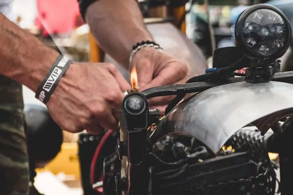 hands of man working on a motorcycle