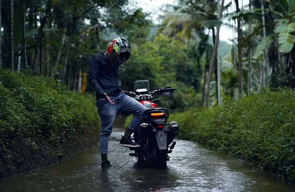 Man with motorcycle in deep water