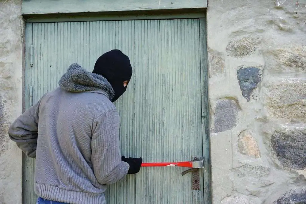 Burglar breaking into a door