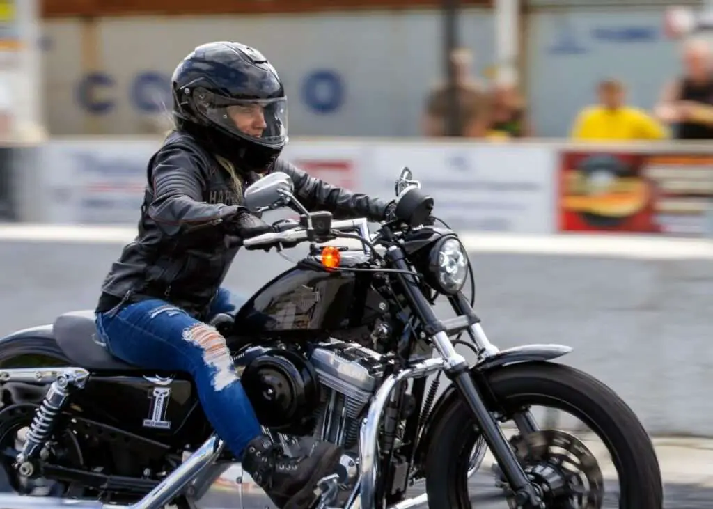 Woman riding a black motorcycle
