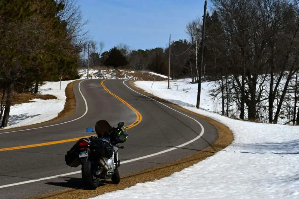 Motorcycle stopped on the side of a winding road