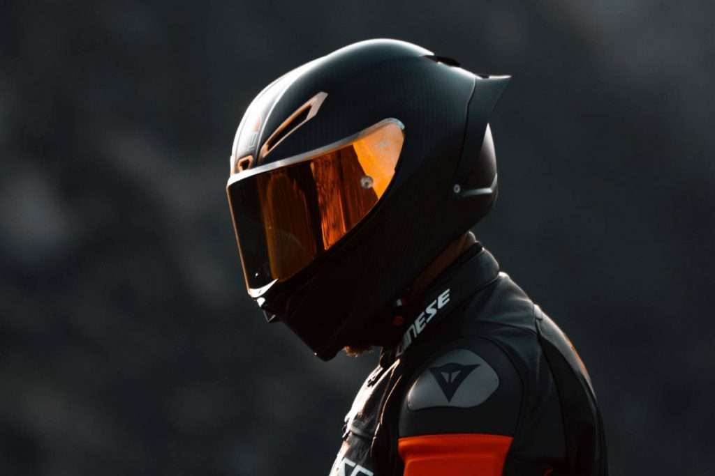 Rider wearing a black helmet and a Dainese jacket