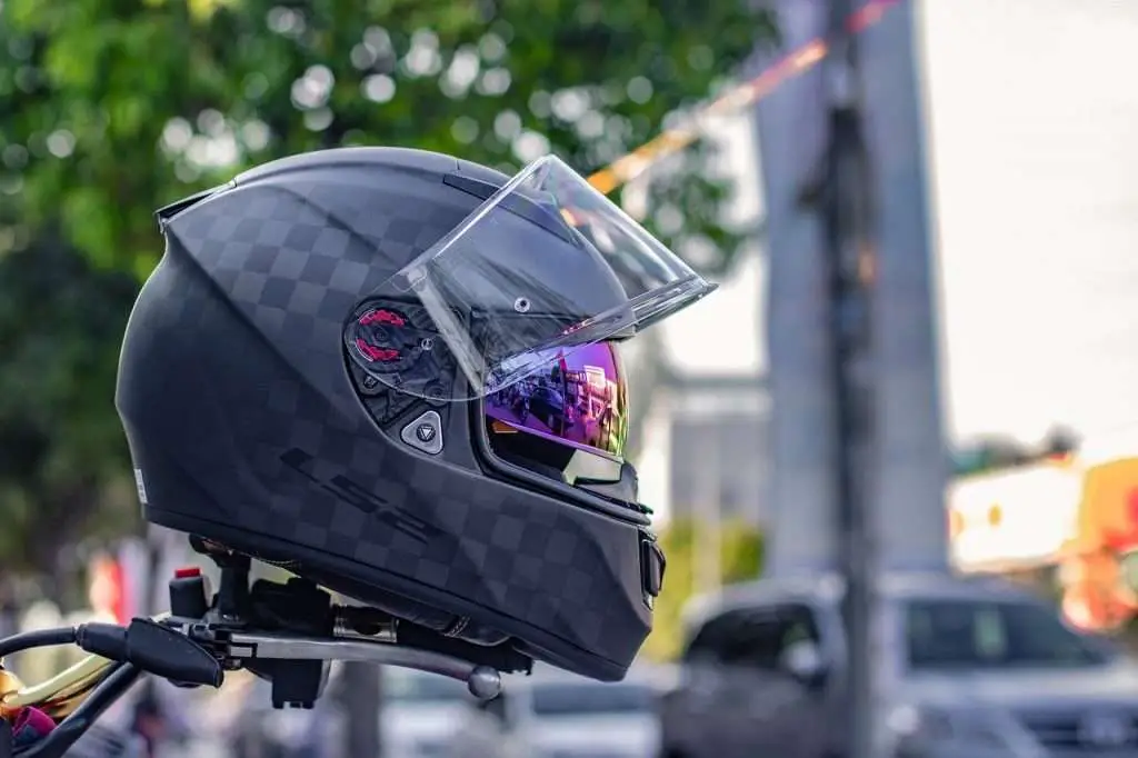 A black motorcycle helmet on handlebars