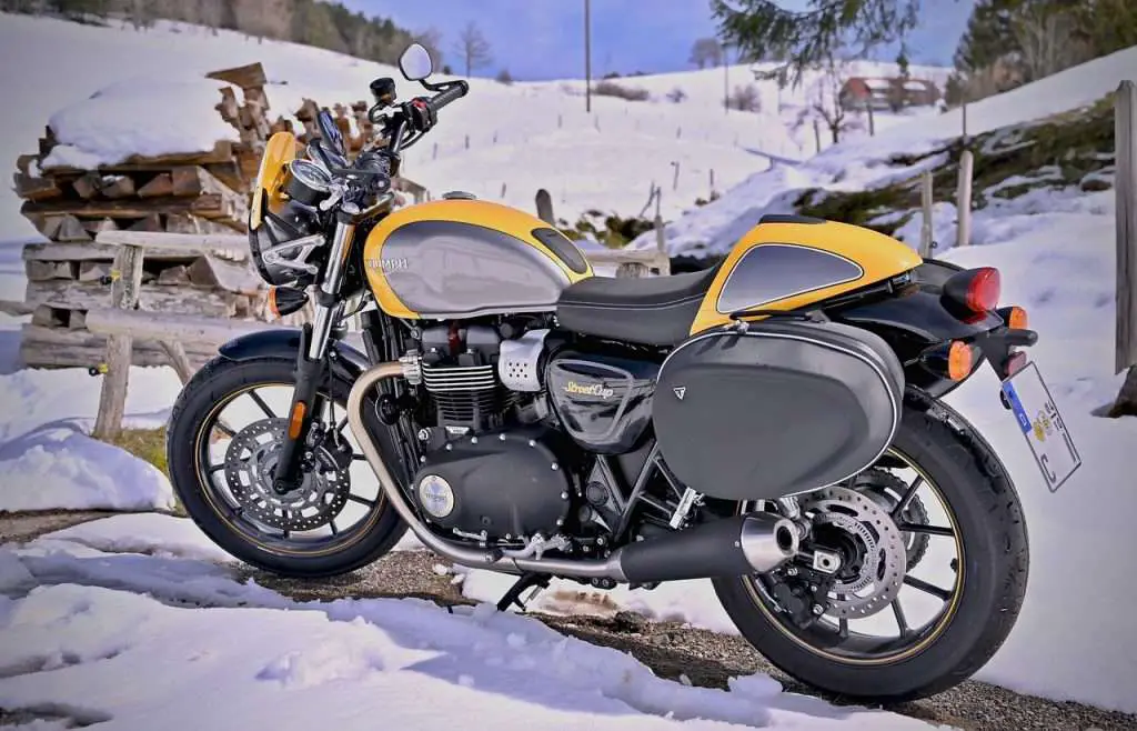 Yellow Triumph motorcycle with snow in the winter