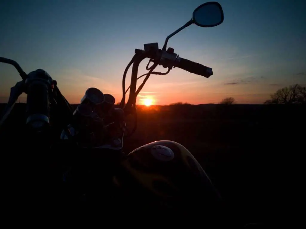 Motorcycle handlebars at sunset