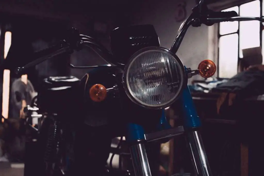Motorcycle in a garage with headlight off