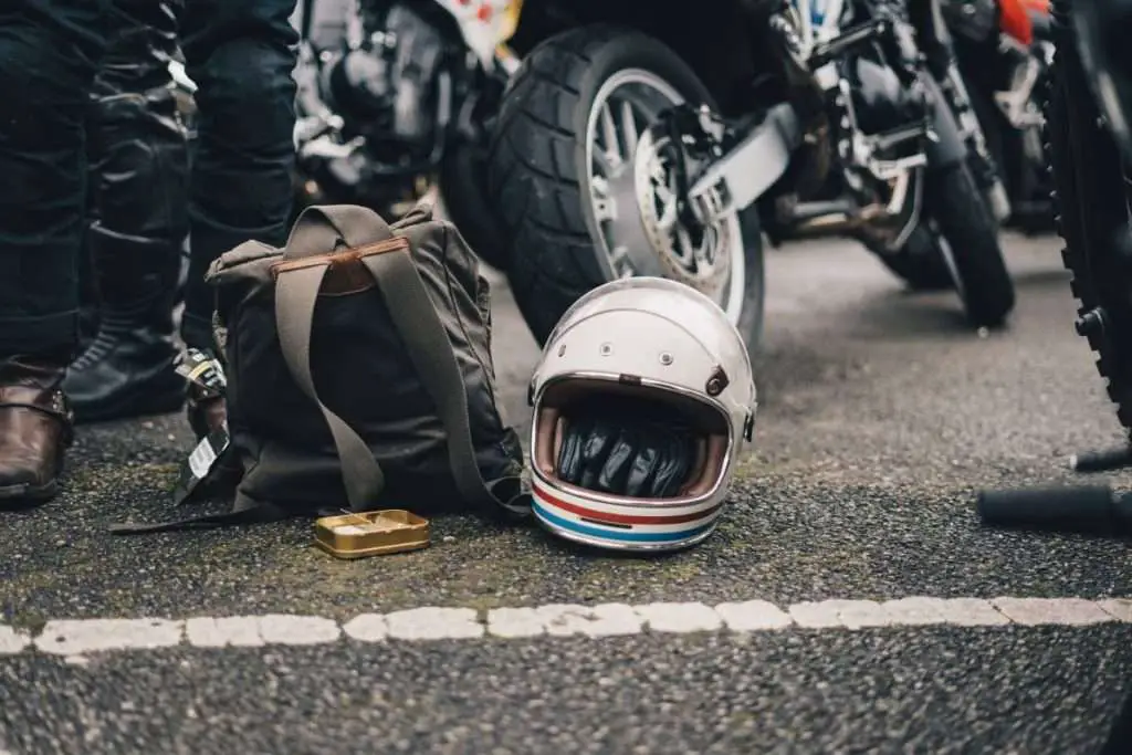 Old white motorcycle helmet placed on the ground