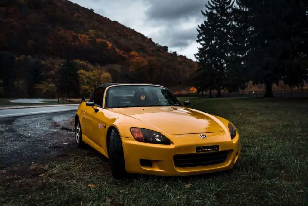 Yello Honda S2000 on the side of the road