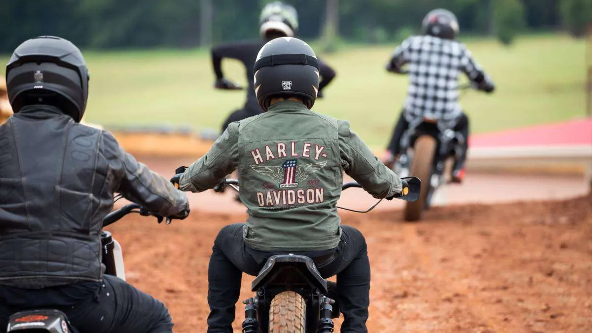 4 Dirt-bike riders wearing motorcycle jackets