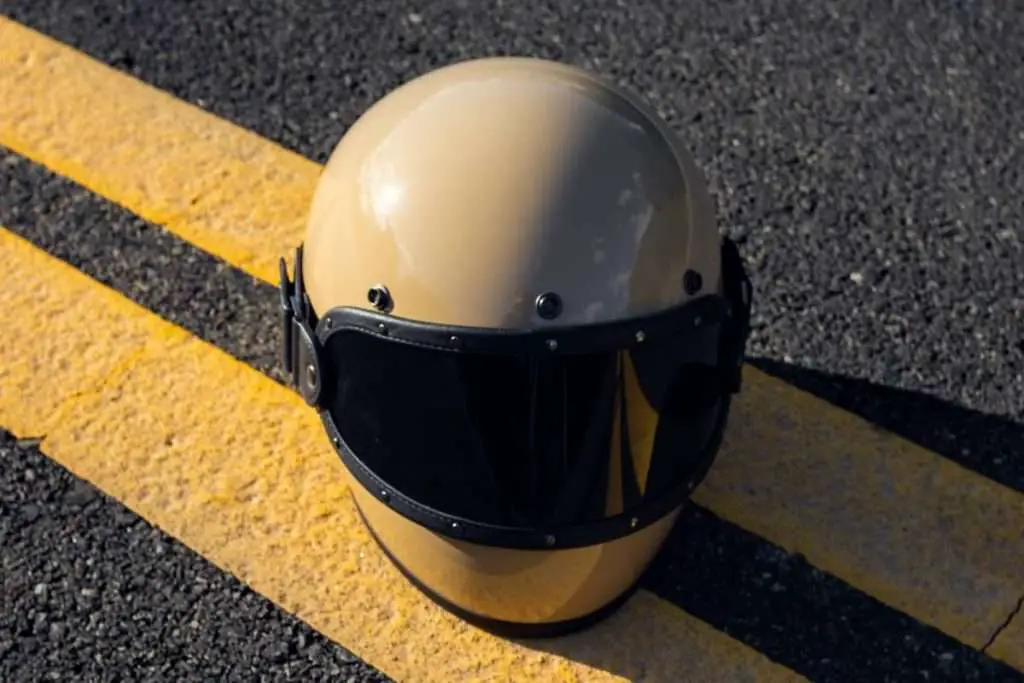 Beige motorcycle helmet on the ground