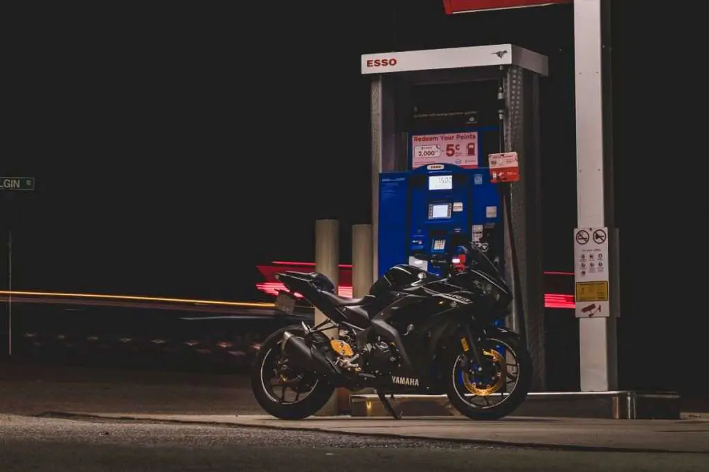 Black Yamaha motorcycle next to a gas pump in Canada