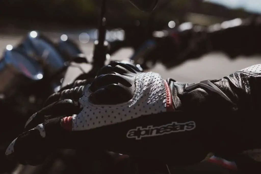 Close-up of an Alpinestars Motorcycle glove on the handlebar