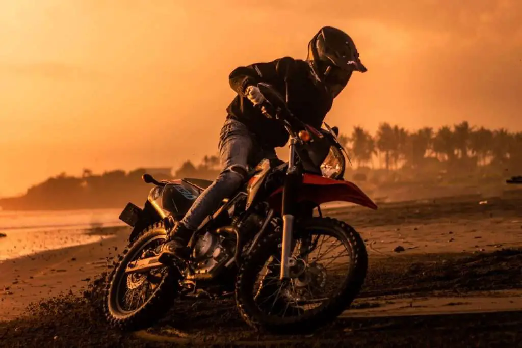Motorcycle rider on enduro bike at dusk